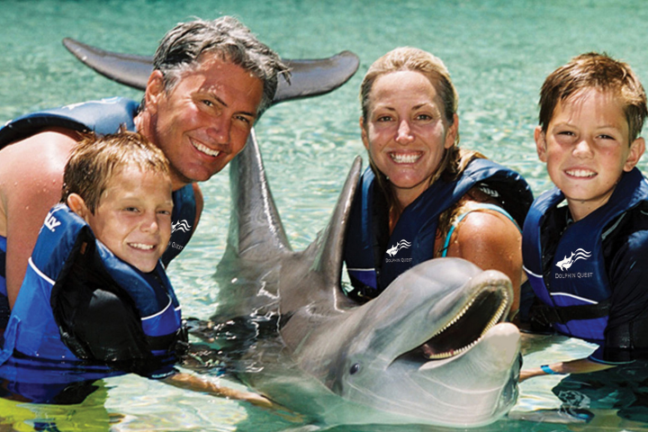 A family wearing wetsuits having a dolphin tour experience.