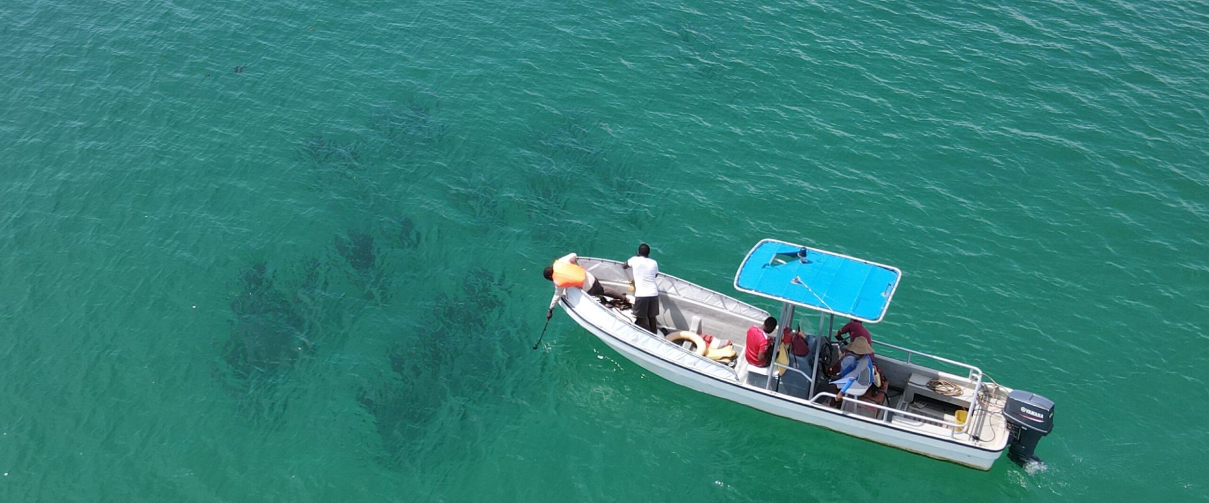 A boat with people on it sailing in the water. A boat with people on it sailing in the water.