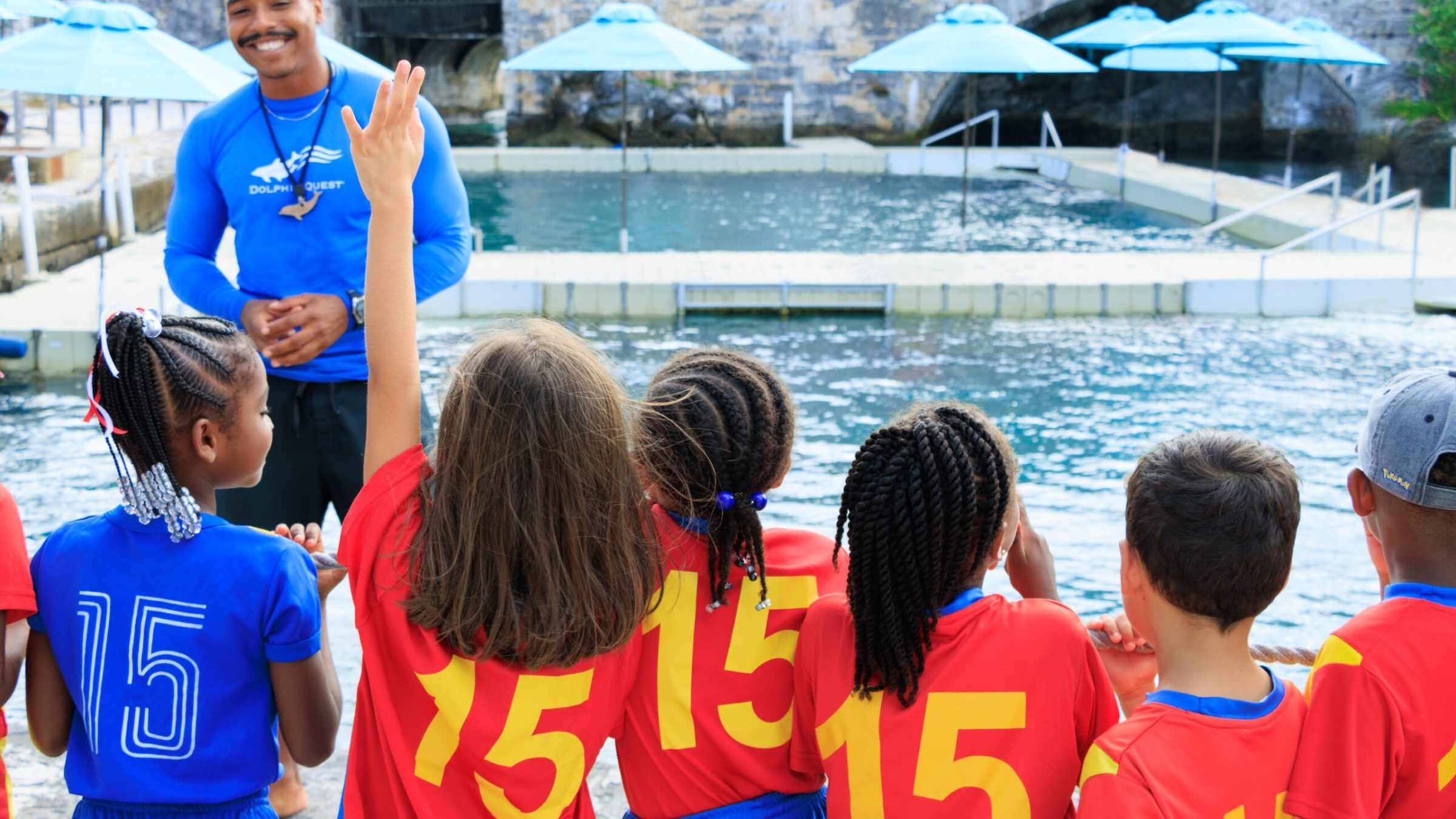 A group of little children in a field trip having an orientation with the Dolphin Quest crew.