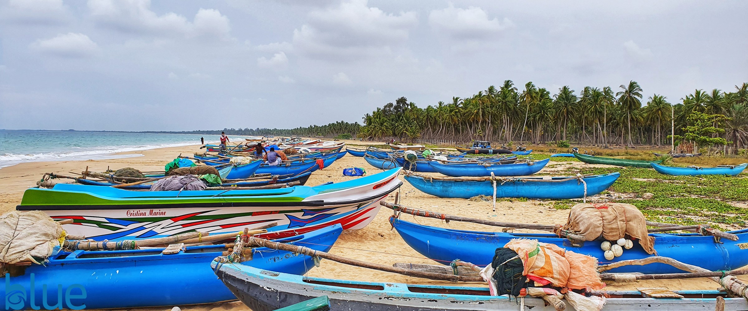 fishing canoes waiting on the beach in sri lanka